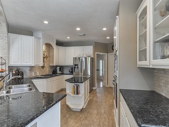 This beautiful kitchen was updated in 2016 with travertine tile floors, granite counter tops, polished marble back splash and stainless steel appliances.