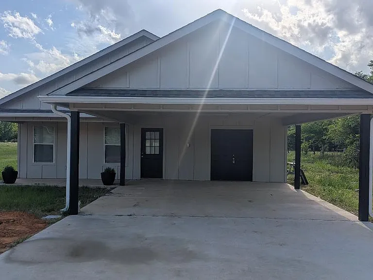 CARPORT AND ENTRANCE OF HOUSE