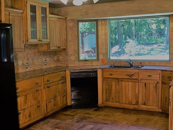 Notice the side by side refrigerator, dishwasher, gas stove top and oven