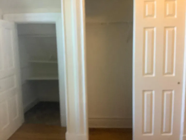 Closet with open door in the second bedroom