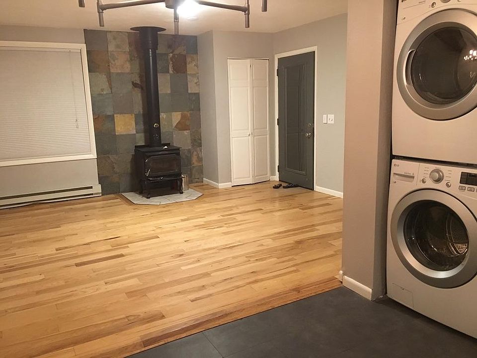 Looking toward the living room and front door from the kitchen. Note the coat closet by the door.