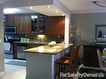 Renovated Kitchen & Dining Area
						:
						Partial view of spacious kitchen and dining area with granite breakfast bar