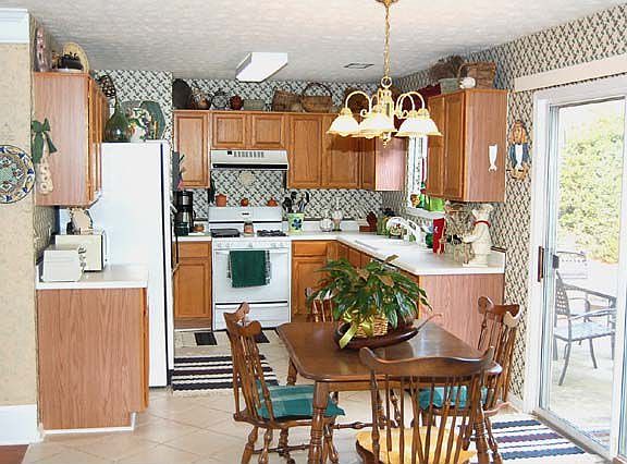 Very efficient kitchen with Corian countertops and tile floor.