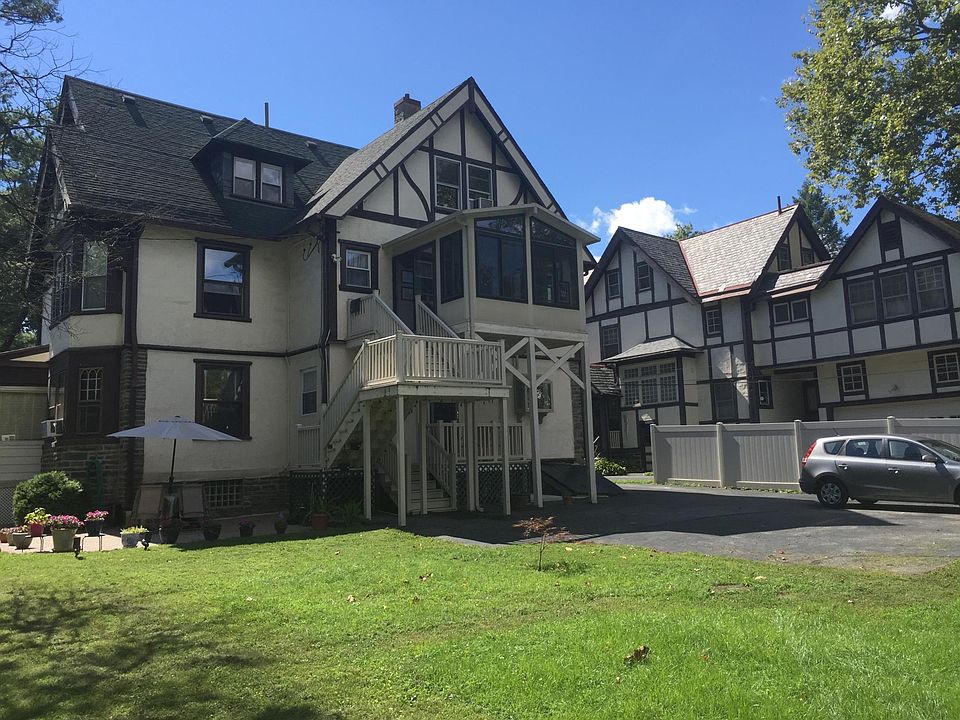Back of the house, tenant parking and stairs to entrance
