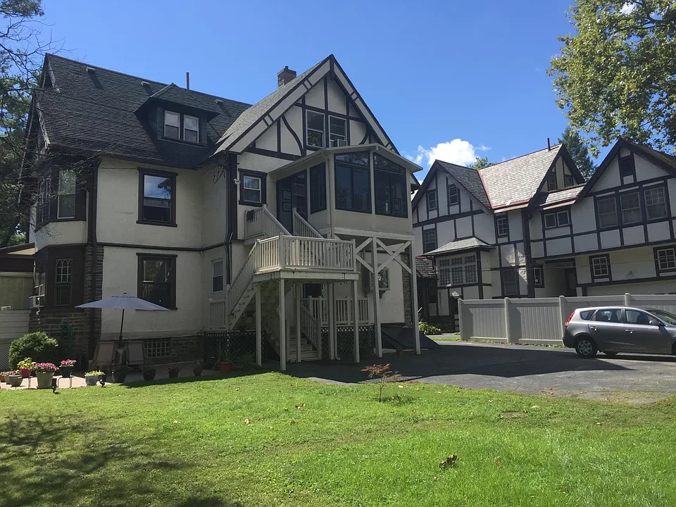 Back of the house, tenant parking and stairs to entrance