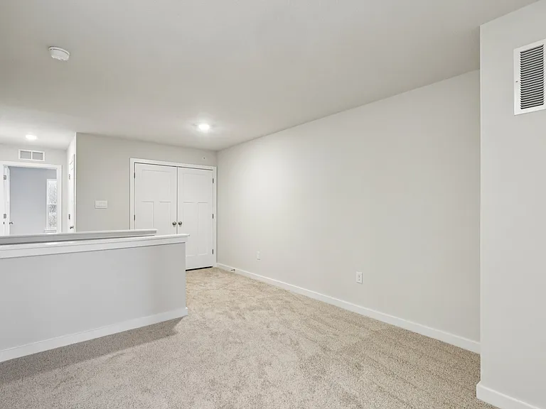 Large Loft with lighting and access to the hallway, laundry closet and linen closet