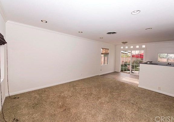 Living Room View from front door. Dining Area next to sliding doors, kitchen is open to living room 