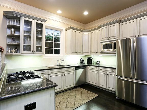 Fabulous kitchen is a cook's delight! Features wood cabinets (some with glass fronts), high end stai