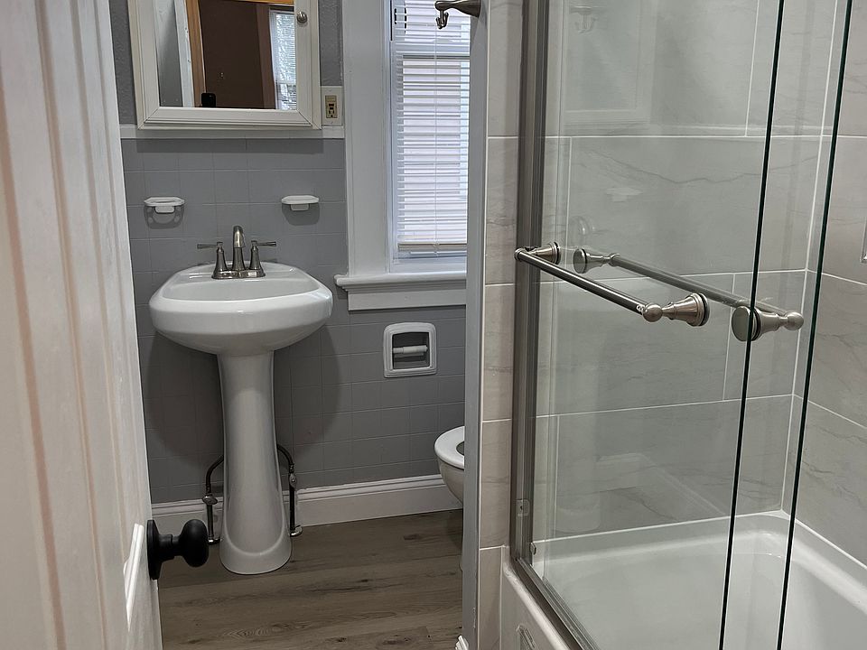 Completely remodeled full bathroom. New tub, tiling, flooring, lighting, pedestal sink, fixtures and toilet.