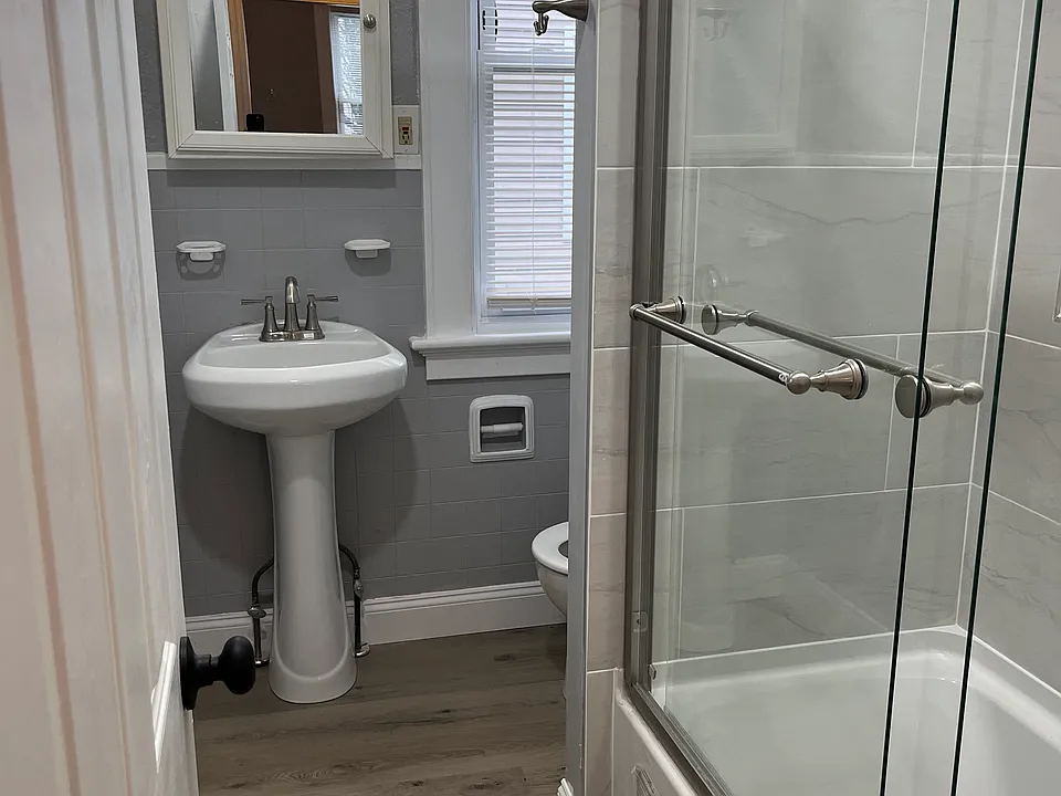 Completely remodeled full bathroom. New tub, tiling, flooring, lighting, pedestal sink, fixtures and toilet.