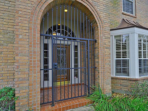 Arched entry with wrought-iron gate.