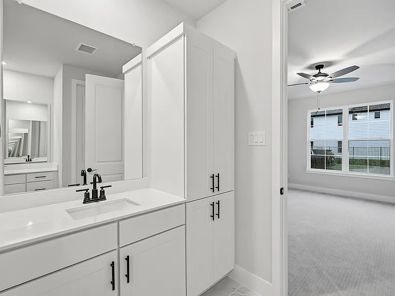Primary bathroom with separate vanities and a huge walk-in closet