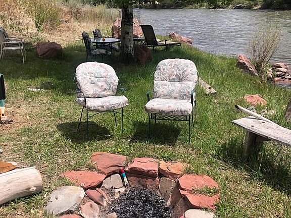 View of river property with fire pit