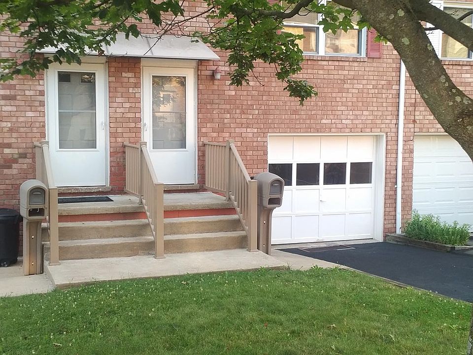 Norway maple shades the 2-car driveway and the front lawn.
