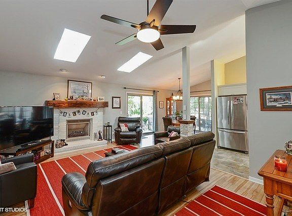 Enjoy the gas log fireplace for those chilly evenings!  Ceiling fan with light, and tons of natural 