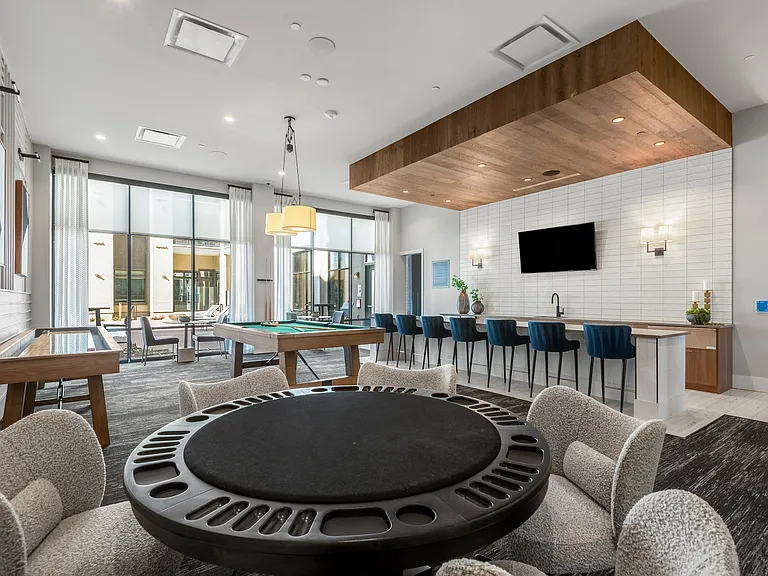 Resident Lounge with Bar Seating, Game Tables, and Access to Patio Views