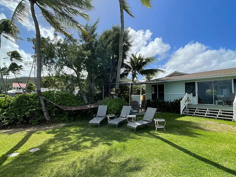 Yard: lounge chairs, hammock between 2 coconut trees