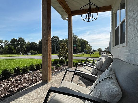 1014 E Valley Trail Drive Front Porch with Herringbone Brick patio and black steel outdoor chandeliers.