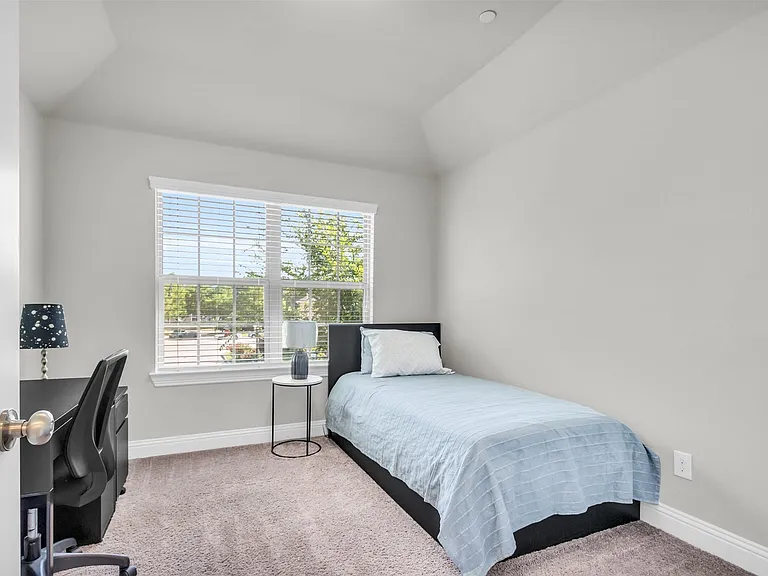 Carpeted room with a large window featuring white blinds, crown molding, and a built-in architectural ceiling detail