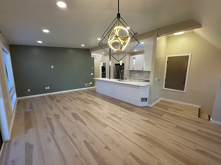 Kitchen, living room, and coat closet from dining room