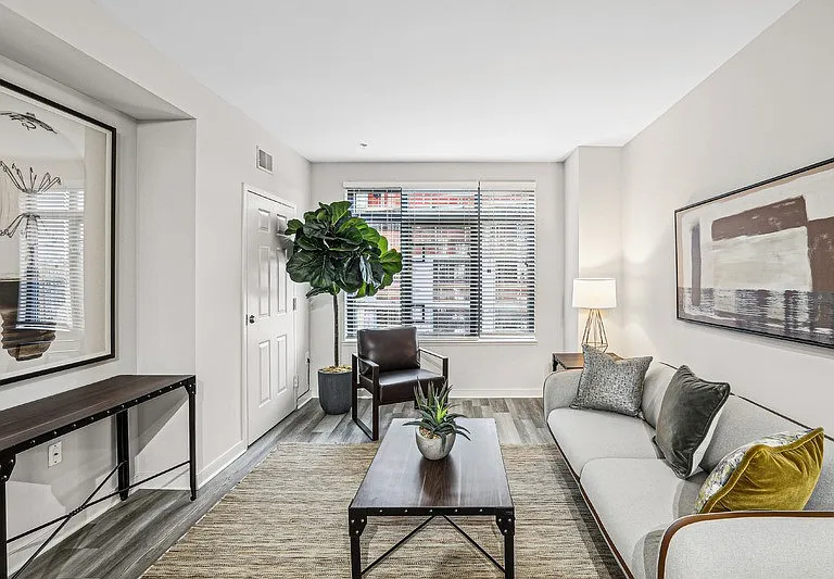 Apartment Living Space Featuring Seating, Artwork, and Console Table