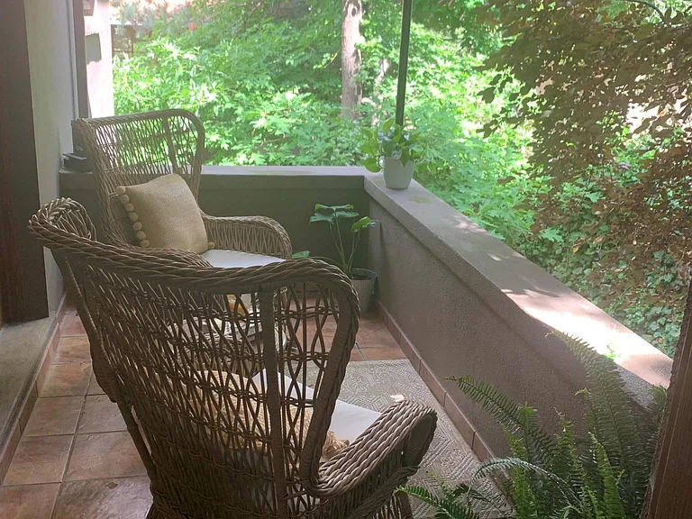 Side covered porch great for coffee in the morning.