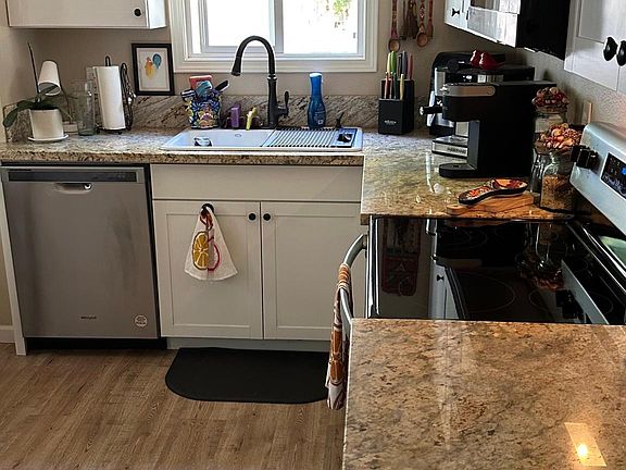 New dishwasher, oven/stove, microwave, and stainless steel fridge.