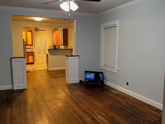 Living room looking into dining then kitchen