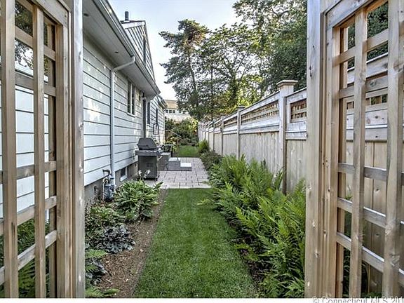 Welcoming entrance through your Arbor to the perfectly landscaped side yard with patio! This area also has an entrance to the kitchen mud area