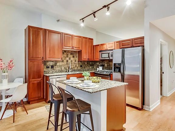 Kitchen - note open space above cabinets and fridge is now enclosed with a window to fully enclose the second bedroom