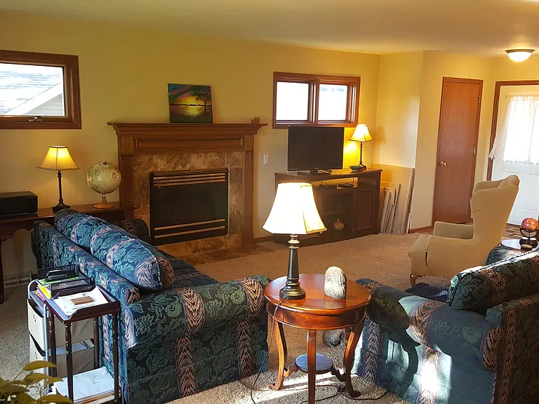 Open_concept layout with natural light and cozy living room fireplace.