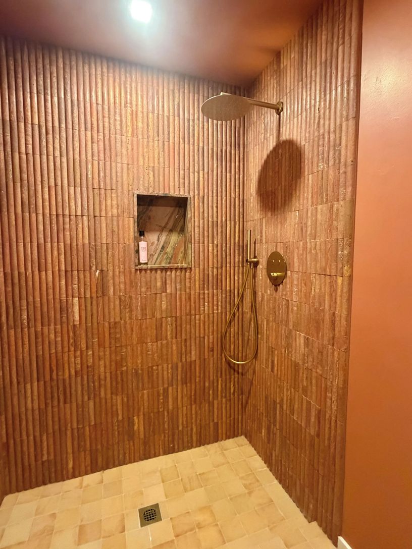  Terracotta tiled colored drenched bathroom with European shower fixtures