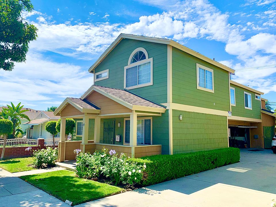 3 bed 3 bath home, with front porch and lawn and attached two-car garage