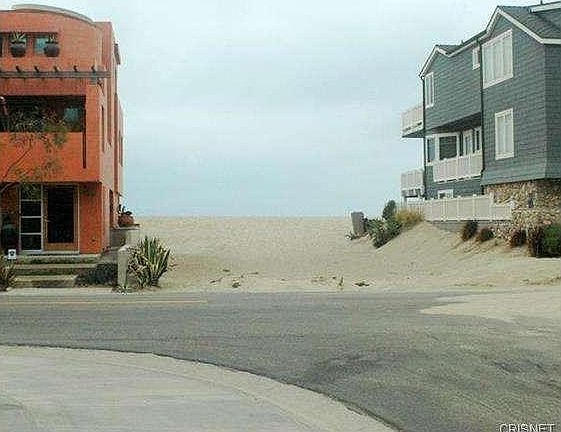 Beach access approximately 100 ft from front door at corner of L