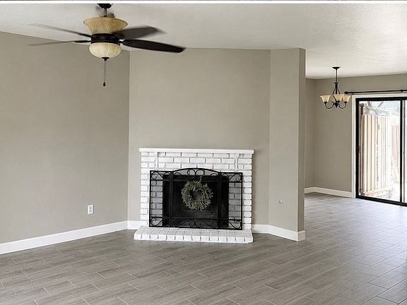 Spacious living room with a warm, gas-burning fireplace.