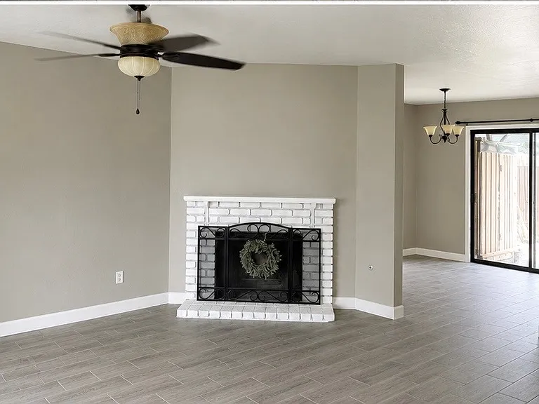 Spacious living room with a warm, gas-burning fireplace.