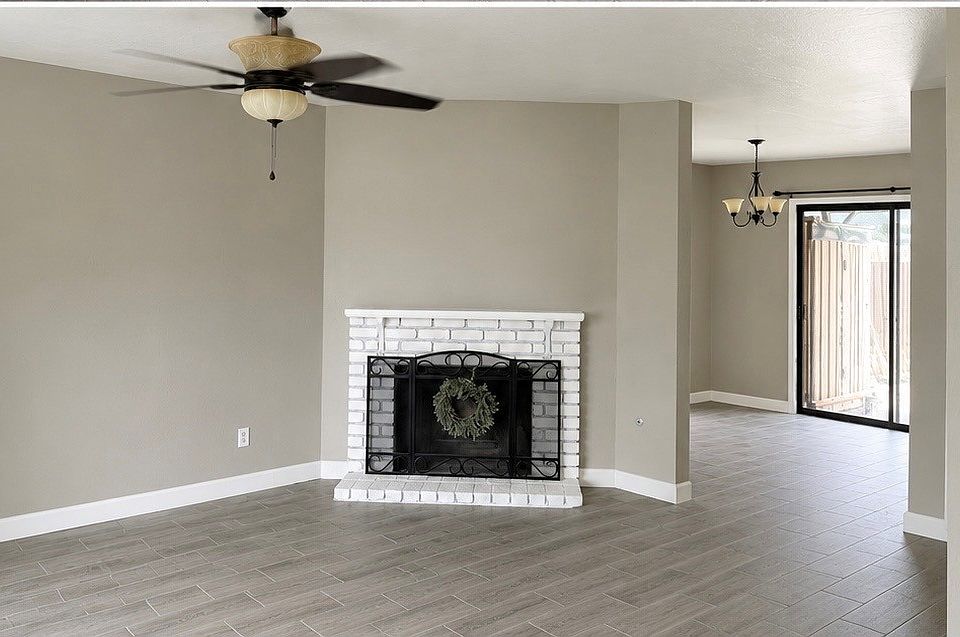 Spacious living room with a warm, gas-burning fireplace.