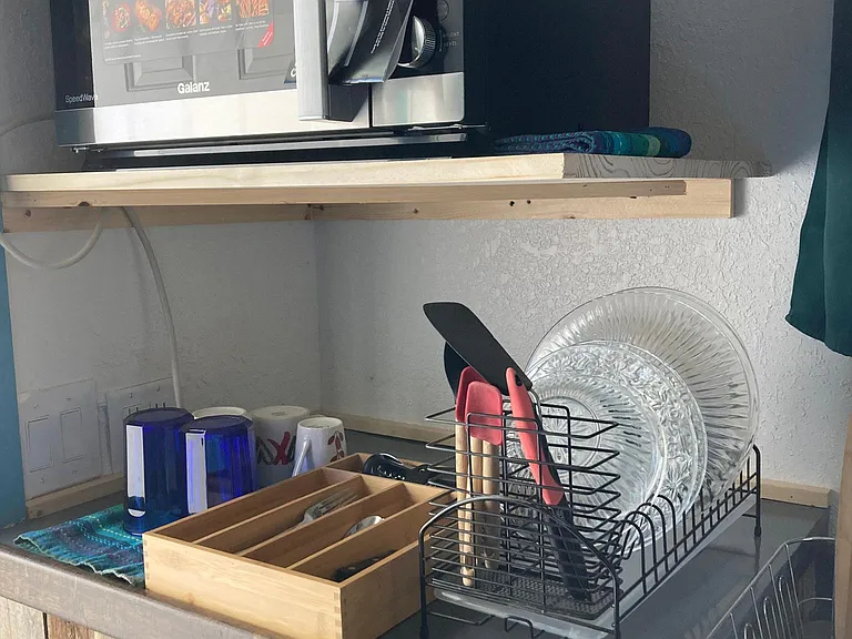 close up of the convection/air fryer/microwave oven and some of the kitchen supplies