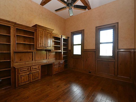 French doors open to the study accented by hand scraped hard