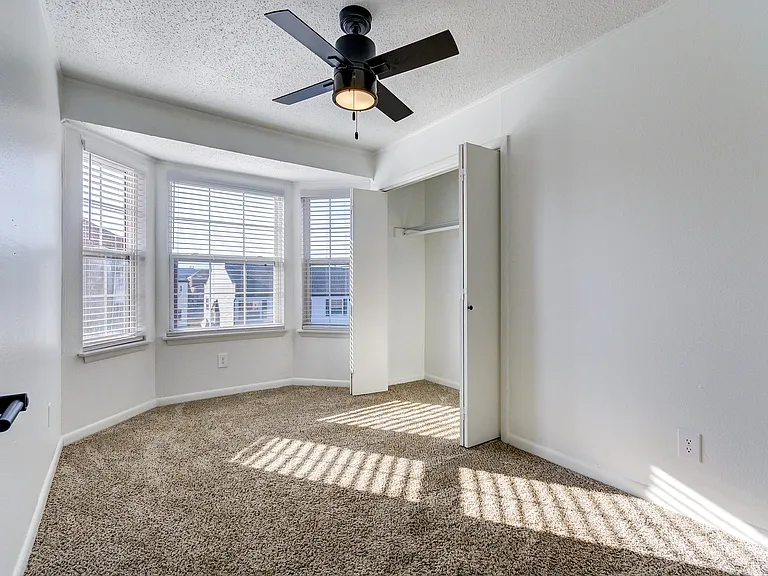 A bright living room with ceiling fan and vinyl floor is shown at ReNew on Cantrell.
