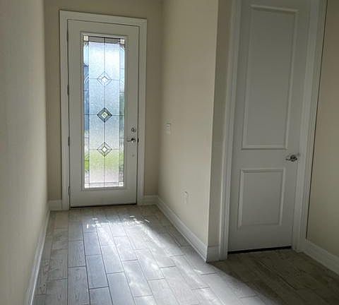 Front door and door leading to third (out of 4) bedroom