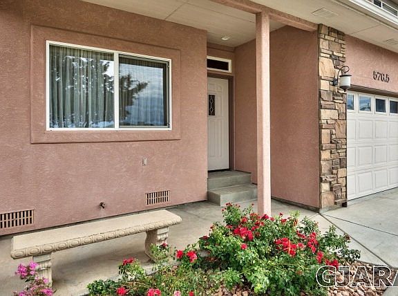 This townhome's covered front porch leads you into a townhome with three bedroom