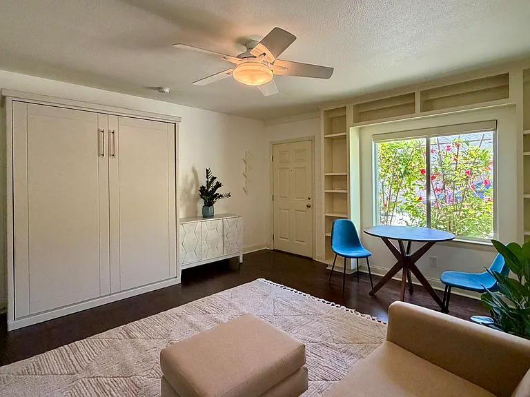 Living space facing wall cabinet bed.