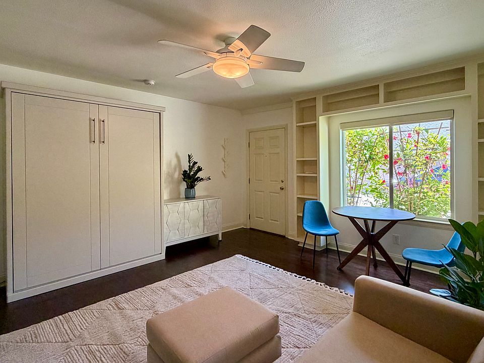 Living space facing wall cabinet bed.