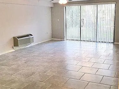 Large and light second bonus room with slider leading to backyard and the community pool.