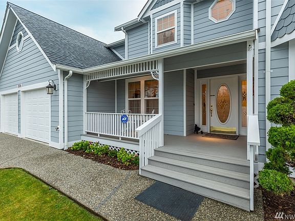 Covered front entry w/elegant front door w/side lights.