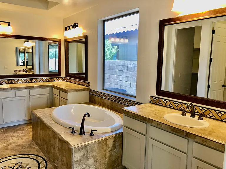 Primary bathroom with soaker tub and dual sink countertops