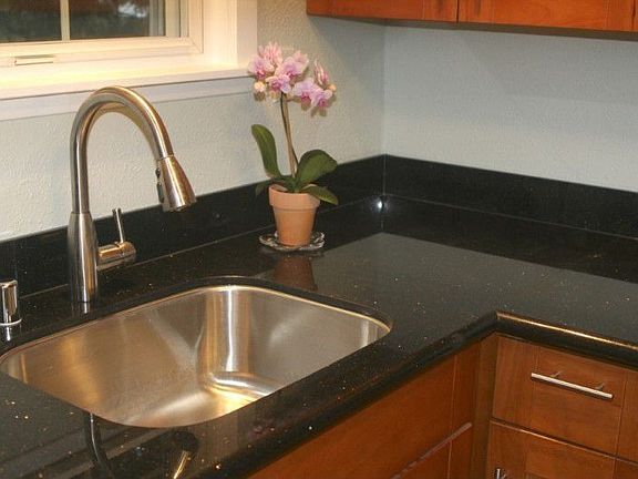 Sparkling granite counters and undermount sink.
