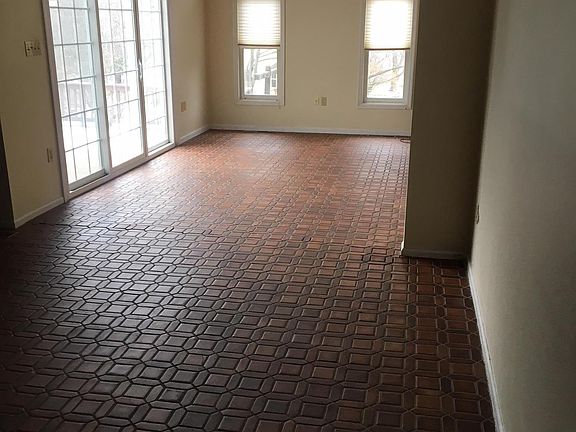 living room with vaulted ceiling and patio exit