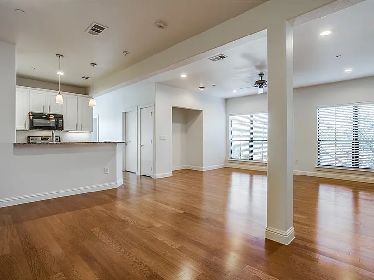 Open floorplan with gleaming hardwood floors.